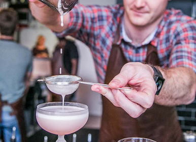 Barman inside Sovereign Sands luxurious beach Holiday Villa mixing drinks on the North Coast